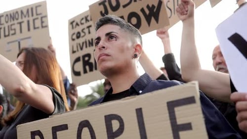 Group activists protest for financial crisis and global inflation holding signs on the street