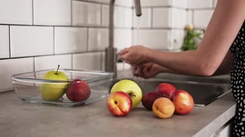 Girl Washes Raw Fruits