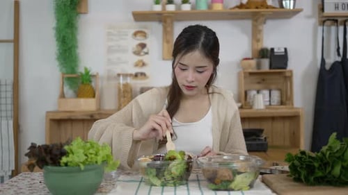 Young Woman Preparing a Fresh Salad at Home