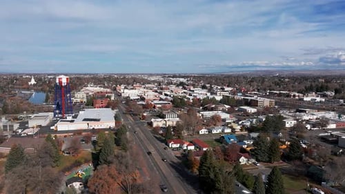 Drone shot panning to the left of downtown Idaho Falls with the water town