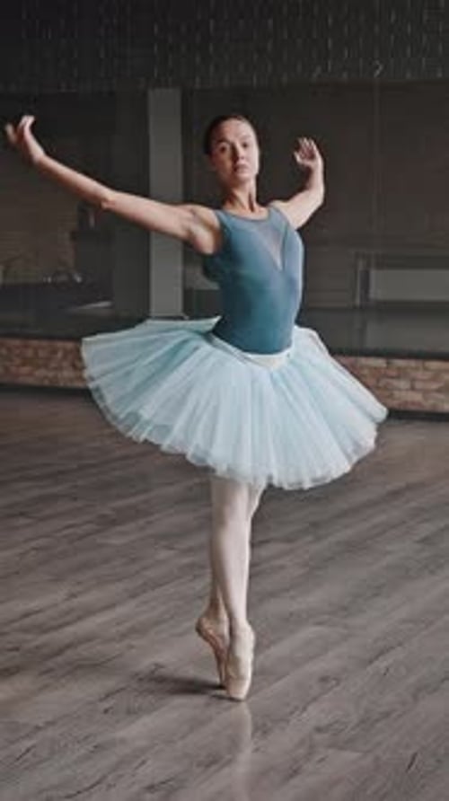 Graceful Ballerina Dancing in a Studio