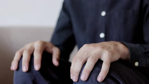 Hands of a nervous and anxious man feeling stress. Close up.