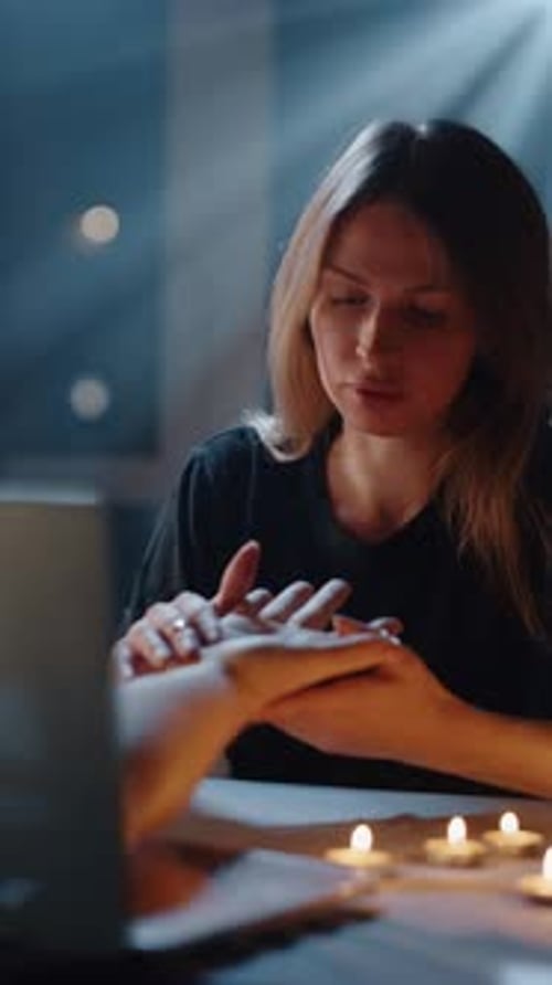 Woman at table having her palm read