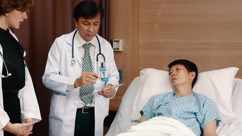 Two doctors stand and talk with medical report.Two doctor talk with sick man in hospital room.