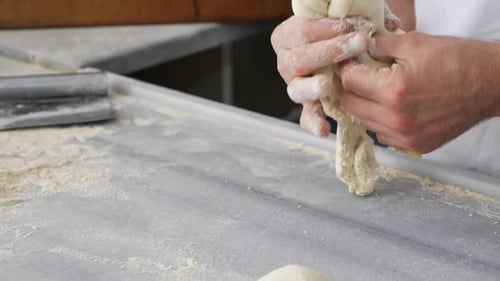 Female Hands Form Pieces of Dough for Baking Bread and Rolls