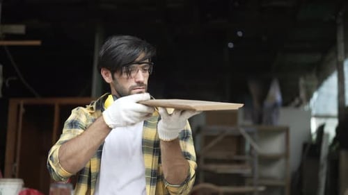 Carpenter make furniture at workshop.