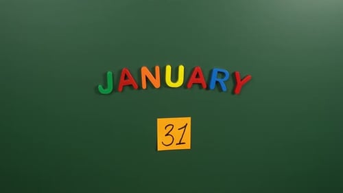 Hand sticking a sticker 31 January calendar day on school board. 31 date of January. Thirty first