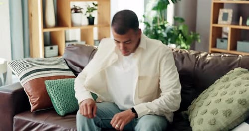 Man Relaxing on Couch in Bright Living Room