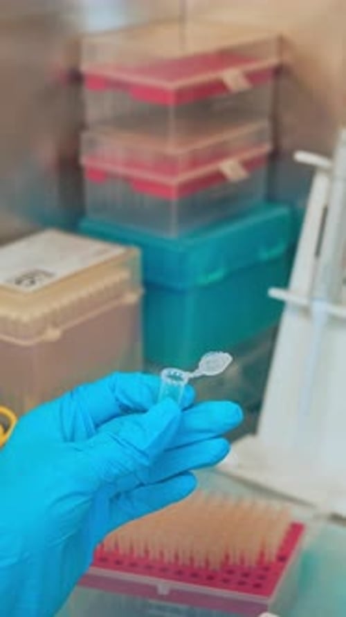 Hand holding test tubes in laboratory. Close up of test tube for taking patient specimen sample