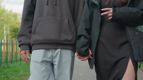 Romantic Young Couple Walking Holding Hands Outside