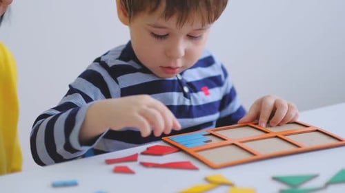Child Plays With Shape-Sorting Puzzle with Adult