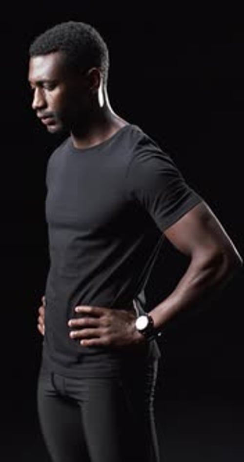 Young Man in Black T-Shirt Posing in Studio