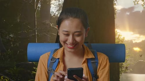 Close Up Of Asian Female Hiker Enjoy Using Smartphone While Exploring Forest Nature