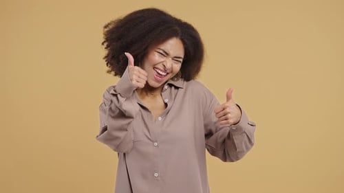 Young Woman Giving Thumbs Up Sign