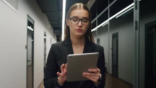 Financial manager using tablet computer browsing online in modern office