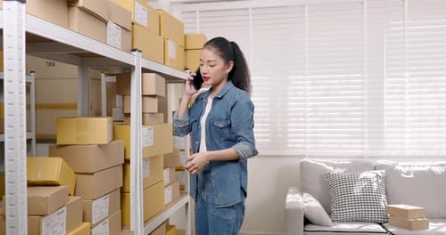 Woman on phone taking package from shelf