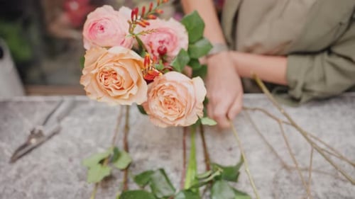 Floral Artist Arranges Wedding Bouquet Meticulously with Tools Floral Designer Carefully Assembles