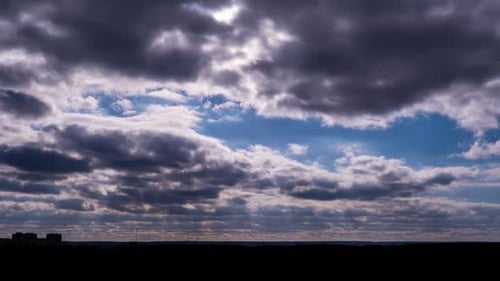 Cumulus Clouds Moving in the Sky with Sun Over the Horizon Timelapse