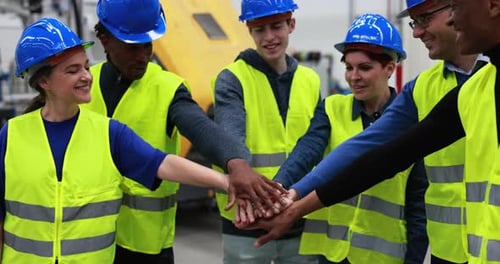 Multiracial Engineers Stacking Hands Inside Robotic Factory Agreement