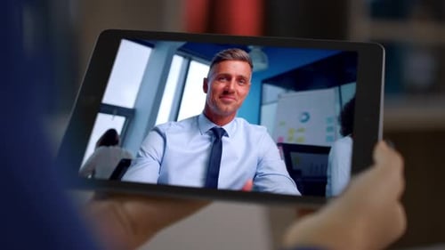 Freelancer Hands Holding Tablet Having Video Call with Office Colleague Closeup