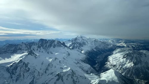 Aerial View Of Mountain Alps Covered With Snow In Winter.