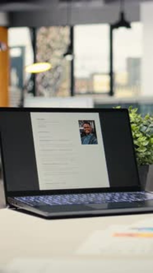 Vertical Video Modern Desk with Laptop in Empty Office Shows Applicant CV