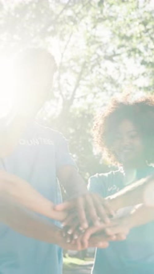 Teamwork, park and hands of volunteer group for charity event, community service and help