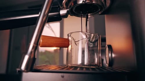 Espresso Machine Pouring Rich Coffee Into Glass