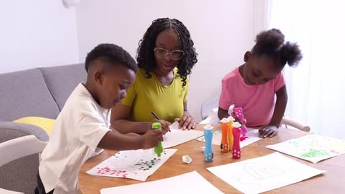 Happy African Family Painting Together at Home