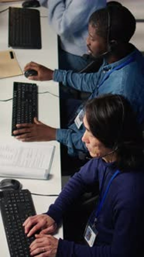 Vertical Video Call Center Coworkers in Diverse Office Helping Customers