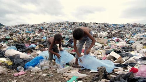 Children Scavenging in Vast Polluted Landfill