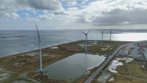 Panoramic view: a source of clean energy, four wind turbines in a row, and rotating blades.