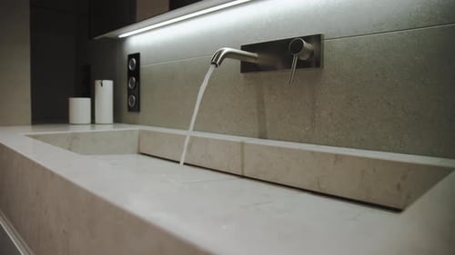 Water From the Modern Tap Fills Into the Marble Sink Empty Bathroom Modern Luxury and Cozy Bathroom