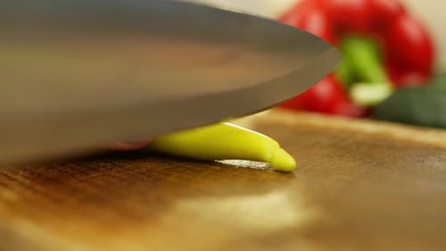 Closeup of a Woman Cutting a Hot Green Pepper