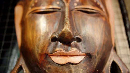 Buddha Mask Made of Wood and Covered with Gold Close Up View
