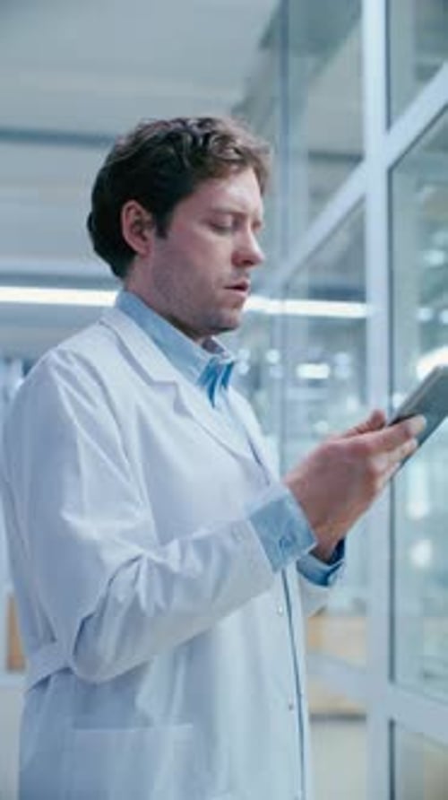 Researcher Working on Digital Tablet in Clinical Laboratory