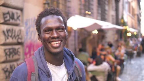 Young Adult Smiling in Urban Cityscape
