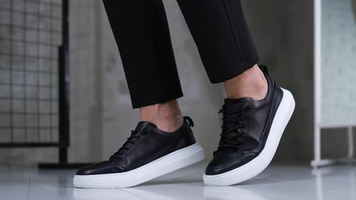 Adult Wearing Black Shoes with White Soles