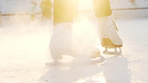 A Woman Skating on Ice Rink Slowing Down