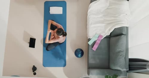 woman in sportswear watching fitness online video on tablet practice yoga for beginner at home.