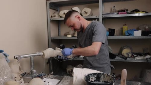 Man Working on Medical Device in Workshop