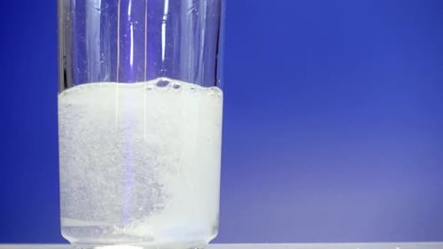 Effervescent Tablet Dissolving in Glass of Water Close-Up