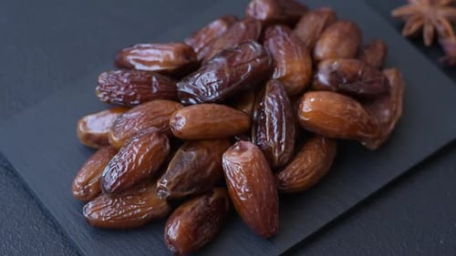 Dried dates on a ceramic plate for Ramadan or Iftar. Dates fruit as a background