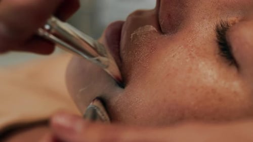 Women Massage Their Faces with Brushes