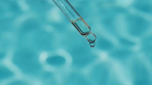 Clear Dropper Drips Liquid Macro Blue Background