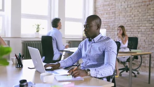 Young business professionals collaborate in a bright modern office workspace