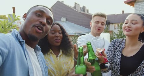Portrait of likable smiling people man woman which celebrating friends meeting on the terrace
