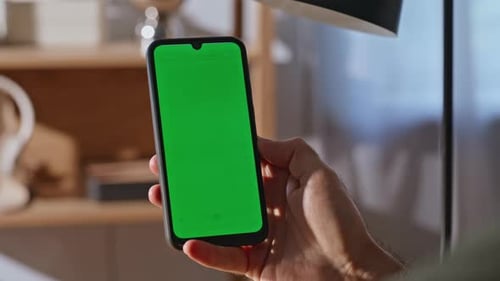 Hand Holds Phone with Chroma Key Screen