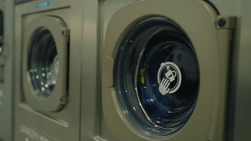 Washing Machines Rotating in Industrial Laundry Room