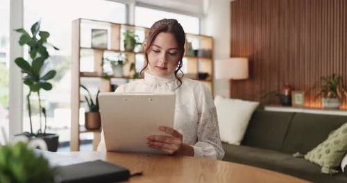 Woman Reviews Documents in Bright Modern Office